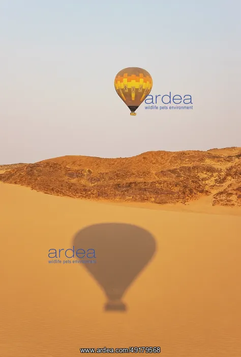 : The hot-air balloon above an arid plain and isolated mountain ridges at the edge of the Namib Desert : The hot-air balloon above an arid plain and isolated mountain ridges at the edge of the Namib Desert