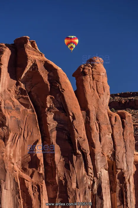 : Hot air balloon flying between buttes, Balloon Festival : Hot air balloon flying between buttes, Balloon Festival