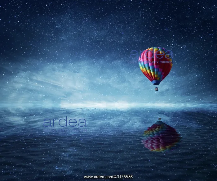 : Hot air balloon flying over the a cold dark blue : Hot air balloon flying over the a cold dark blue