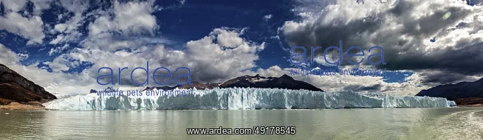 : Idyllic panoramic view of a glacier and mountain range under a dynamic sky : Idyllic panoramic view of a glacier and mountain range under a dynamic sky