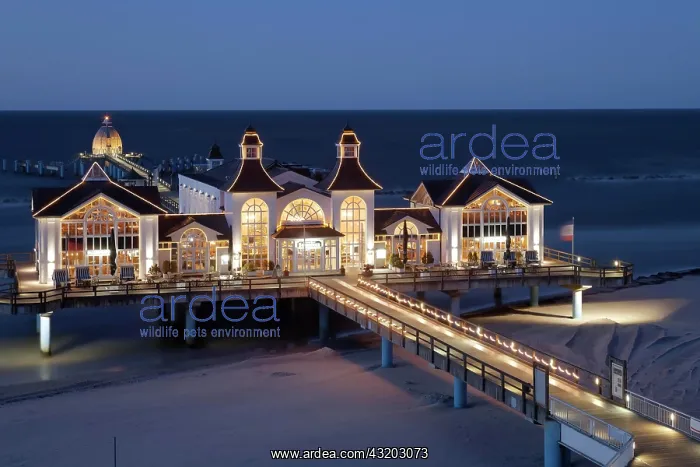 : Illuminated pier at the Baltic Sea in evening mood : Illuminated pier at the Baltic Sea in evening mood