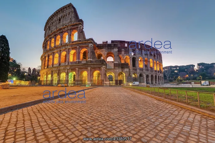 : The imposing Roman Colosseum in Rome in front of : The imposing Roman Colosseum in Rome in front of