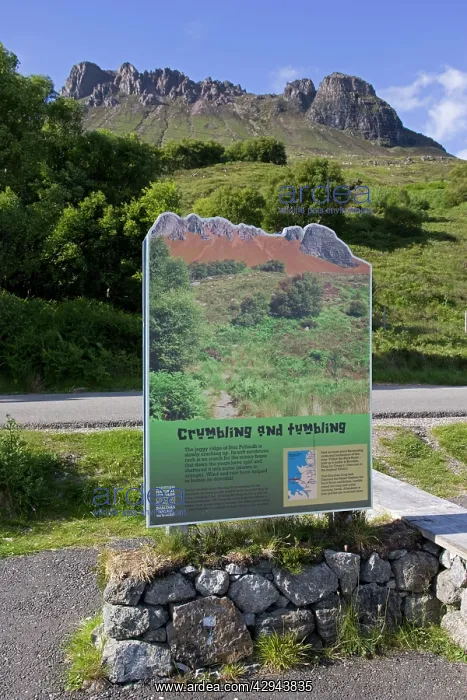 : Information board below rugged sandstone outcrop : Information board below rugged sandstone outcrop