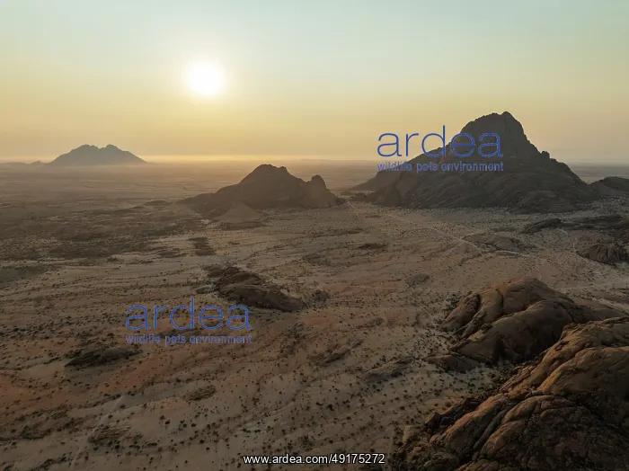  : The isolated Spitzkoppe mountain (1728 m) - on the right - majestically rises above the surrounding desert plains