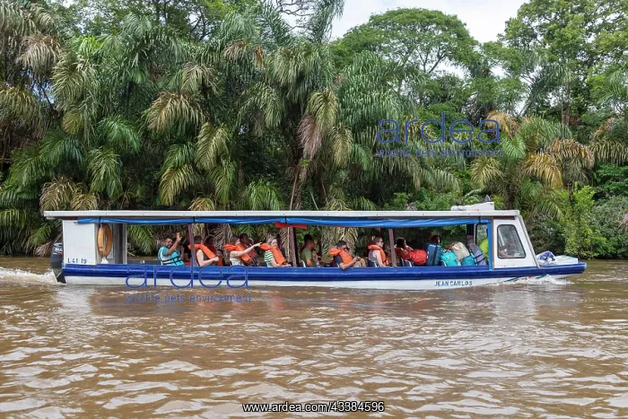 : La Pavona, Costa Rica, Tourists ride boats on the : La Pavona, Costa Rica, Tourists ride boats on the