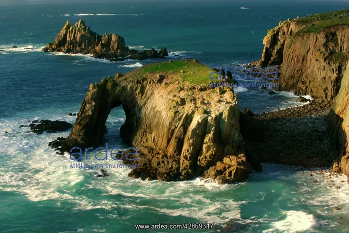 : Lands End - rugged coastline with rock arch in : Lands End - rugged coastline with rock arch in