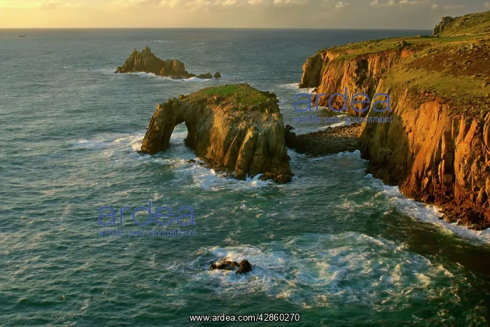 : Lands End - rugged coastline with rock arch in : Lands End - rugged coastline with rock arch in