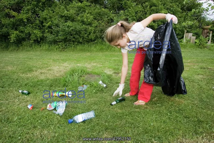 : Litter - Ten year old girl with black bin bag picking : Litter - Ten year old girl with black bin bag picking