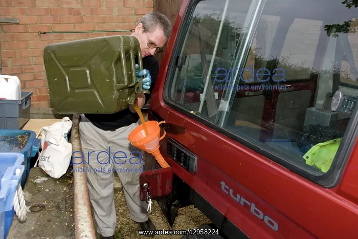 : Mechanic pouring biodiesel made from chip fat cooking : Mechanic pouring biodiesel made from chip fat cooking