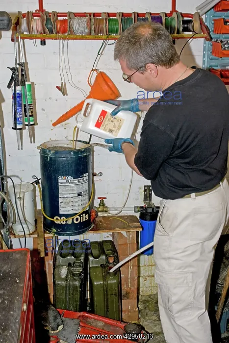 : Mechanic in workshop making biodiesel from used : Mechanic in workshop making biodiesel from used