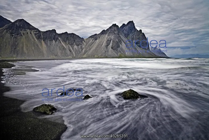 : Mount Vestrahorn, black lava beach with surf at : Mount Vestrahorn, black lava beach with surf at