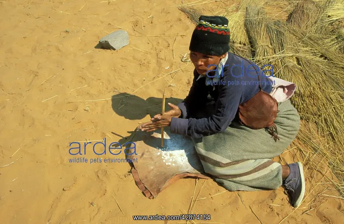 : Namibia - A Kung Bushman / San woman drills holes : Namibia - A Kung Bushman / San woman drills holes