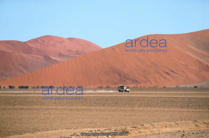 : Namibia - a landrover drives through the valley : Namibia - a landrover drives through the valley