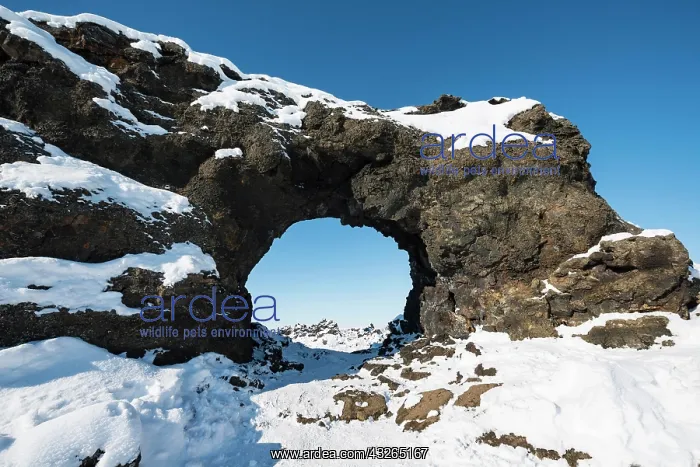: Natural arch, view of a snowy landscape, lava field : Natural arch, view of a snowy landscape, lava field
