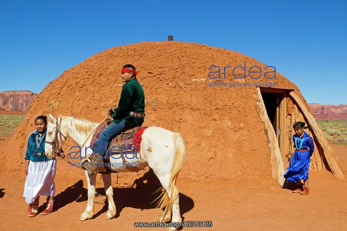 : Navajo Indian - in traditional clothes in front of a Hogan : Navajo Indian - in traditional clothes in front of a Hogan