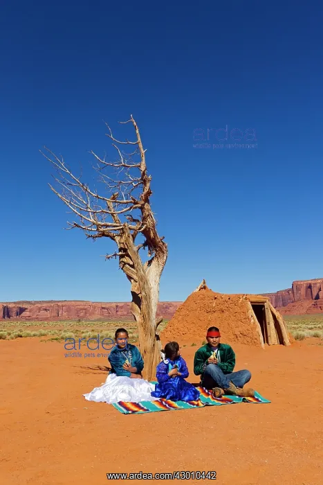 : Navajo Indian - in traditional clothes in front of a Hogan : Navajo Indian - in traditional clothes in front of a Hogan
