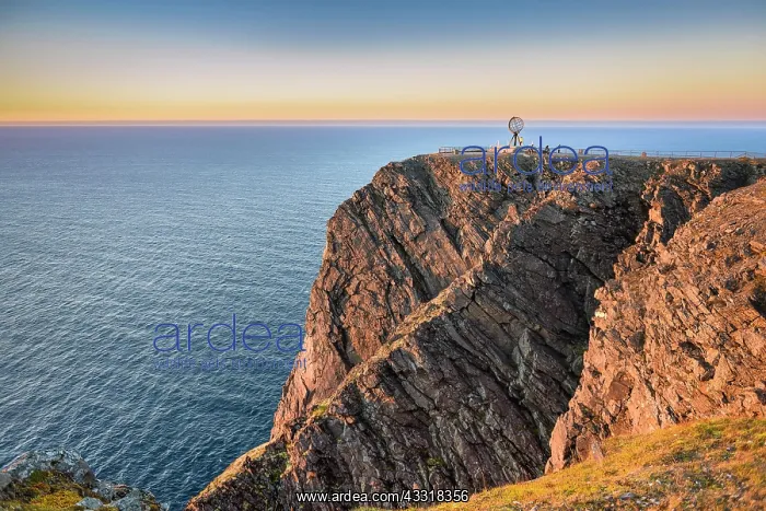 : North Cape cliff with steel globe in the light of : North Cape cliff with steel globe in the light of