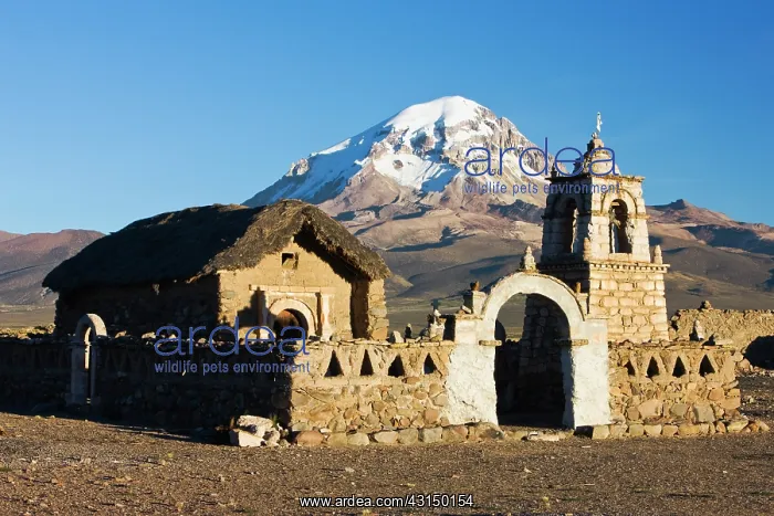 : An old Andean church at sunrise in front of volcanos Parina : An old Andean church at sunrise in front of volcanos Parina