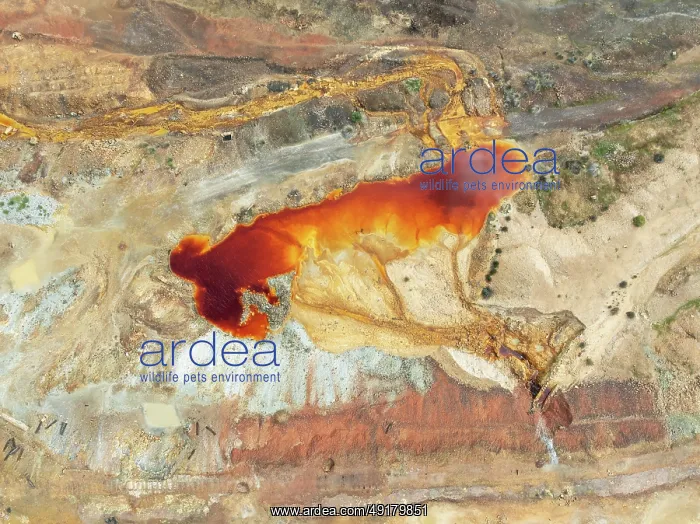 : Old mining site and deep orange-red hues in the water of a pool in the mineral-rich area of the Rio Tinto mines : Old mining site and deep orange-red hues in the water of a pool in the mineral-rich area of the Rio Tinto mines