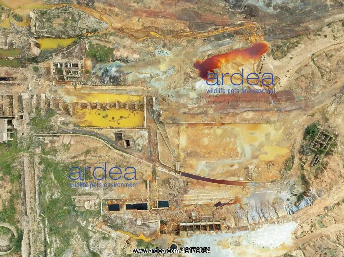 : Old mining site and deep orange-red hues in the water of a pool in the mineral-rich area of the Rio Tinto mines : Old mining site and deep orange-red hues in the water of a pool in the mineral-rich area of the Rio Tinto mines