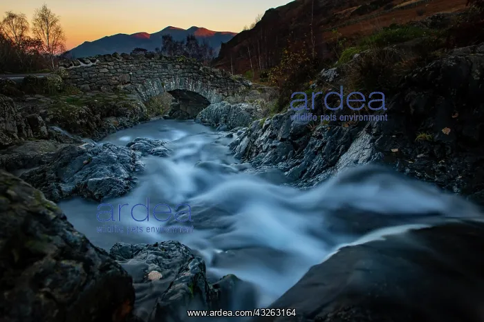 : Old stone bridge with mountain stream, behind mountains : Old stone bridge with mountain stream, behind mountains