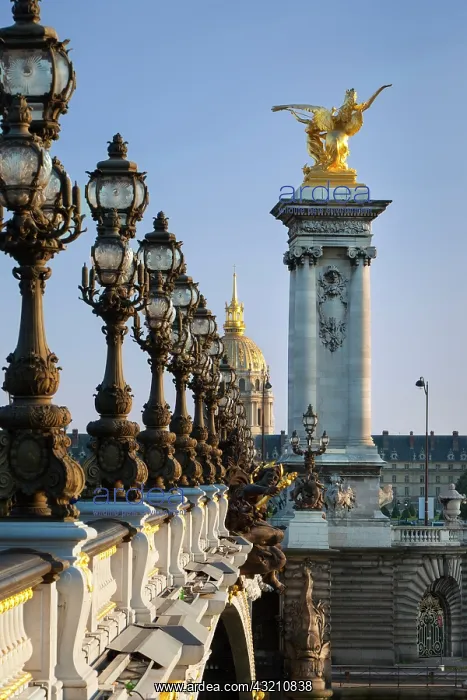 : Ornate lamps along Pont Alexandre III with : Ornate lamps along Pont Alexandre III with