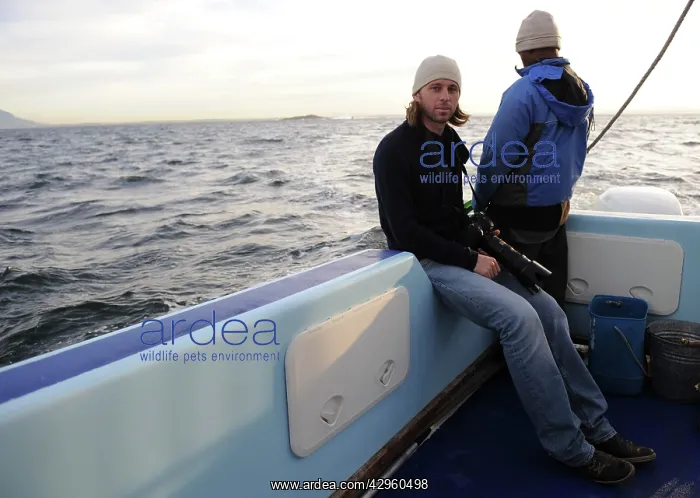 : Photographer - Chris Brunskill in boat photographing : Photographer - Chris Brunskill in boat photographing