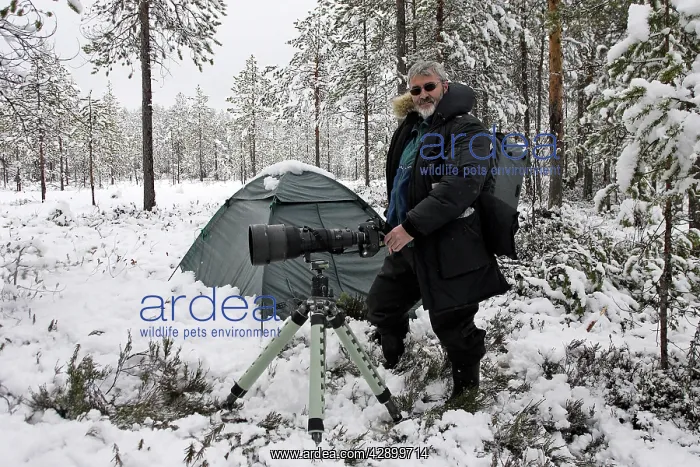 : Photographer - standing by tent with camera : Photographer - standing by tent with camera