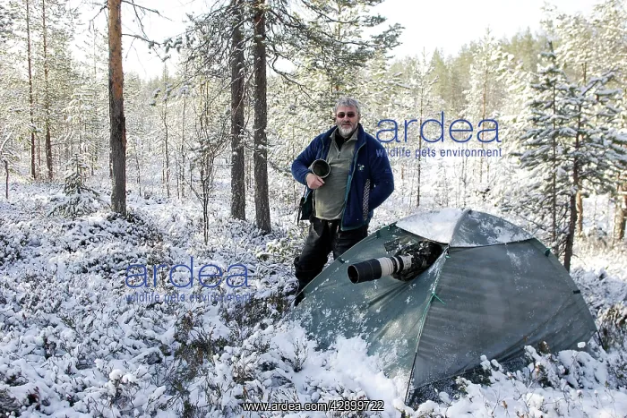 : Photographer - standing by tent with camera : Photographer - standing by tent with camera