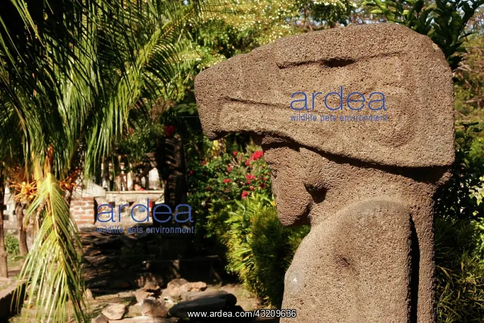 : Pre-Columbian stone statue in front of the church : Pre-Columbian stone statue in front of the church