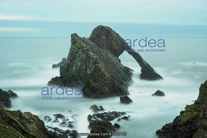 : Quartzite sea arch at dusk, Bow Fiddle Rock, Portknockie : Quartzite sea arch at dusk, Bow Fiddle Rock, Portknockie