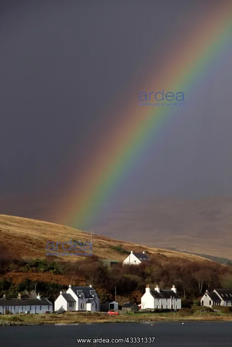 : Rainbow over the houses on Craighouse Island Jura : Rainbow over the houses on Craighouse Island Jura