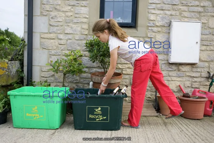 : Recycling - Young girl putting empty bottles in : Recycling - Young girl putting empty bottles in