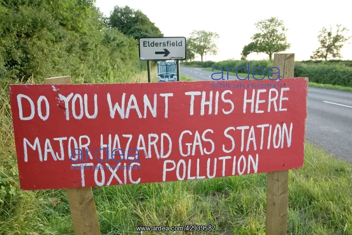 : Red protest sign on roadside against proposed gas : Red protest sign on roadside against proposed gas