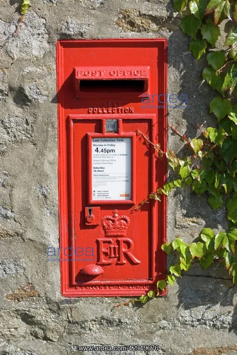 : Red rectangluar Post Office box set in stone wall : Red rectangluar Post Office box set in stone wall