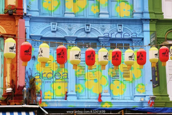 : Red and yellow Chinese lanterns hanging in front of colo : Red and yellow Chinese lanterns hanging in front of colo