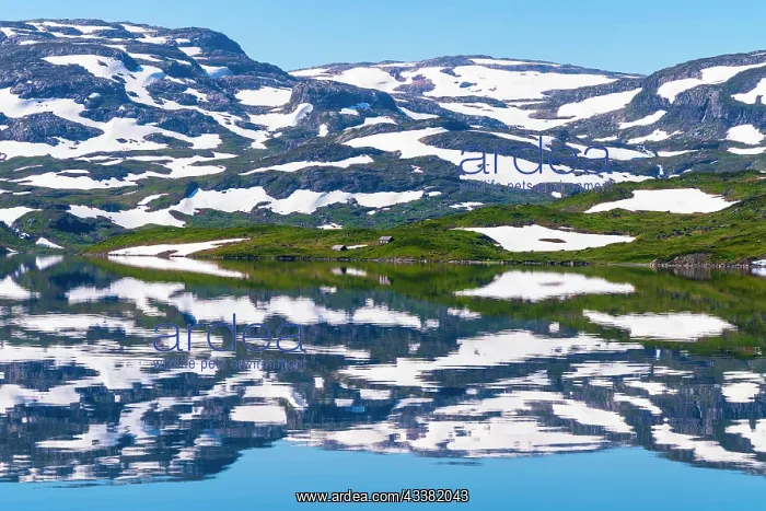 : Reflection of partly snow-covered mountains in Lake : Reflection of partly snow-covered mountains in Lake