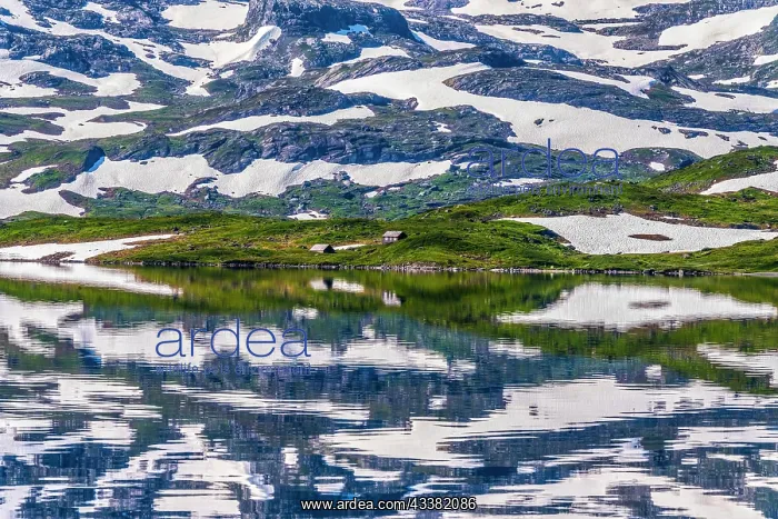 : Reflection of partly snow-covered mountains in Lake : Reflection of partly snow-covered mountains in Lake
