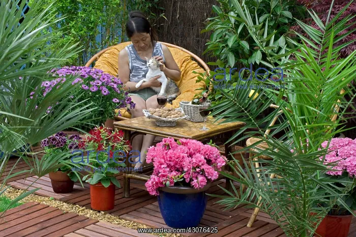 : Resting woman on a flowered garden terrace : Resting woman on a flowered garden terrace