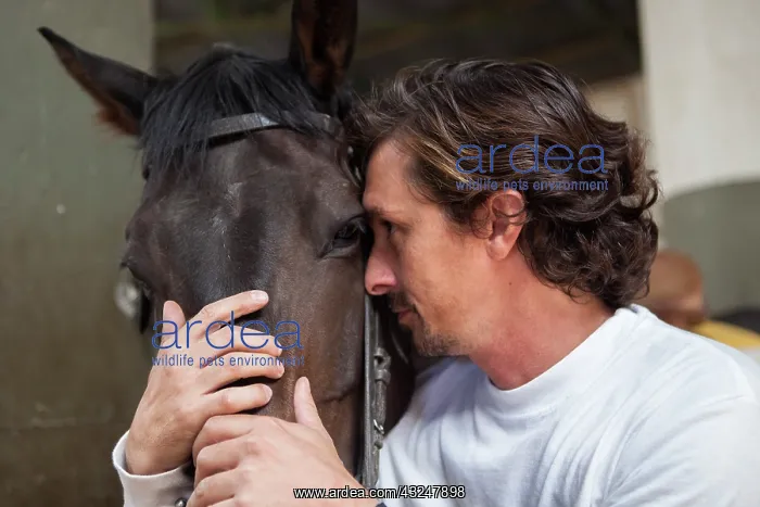 : Riding instructor cuddling a horse - Argentina : Riding instructor cuddling a horse - Argentina