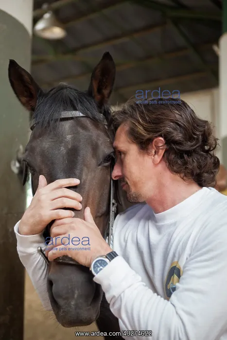 : Riding instructor cuddling a horse - Argentina : Riding instructor cuddling a horse - Argentina