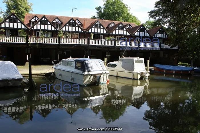 : Row of Boathouses with balcony and with boats moored : Row of Boathouses with balcony and with boats moored