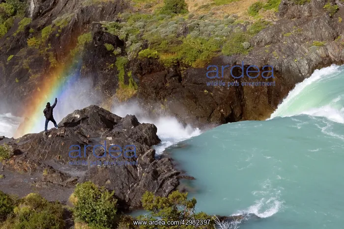 : Salto Grande - hiker stands over a rainbow created : Salto Grande - hiker stands over a rainbow created