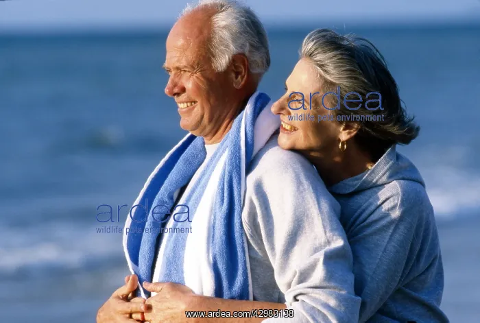  : Senior couple walking on the beach