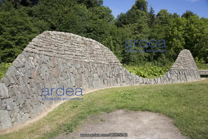 : Sinuous stone wall sculpture representing local : Sinuous stone wall sculpture representing local