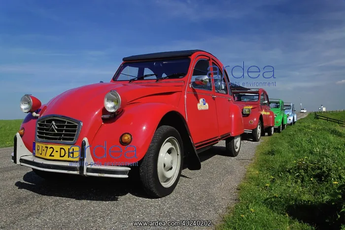 : Small old cars along dike or levee, Holland : Small old cars along dike or levee, Holland