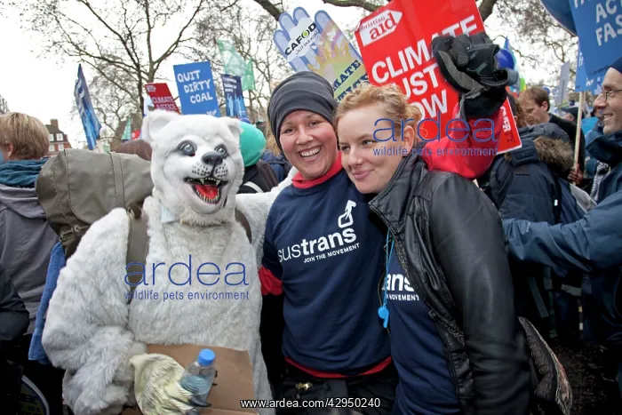 : Smiling Climate campaigners with man dressed as : Smiling Climate campaigners with man dressed as