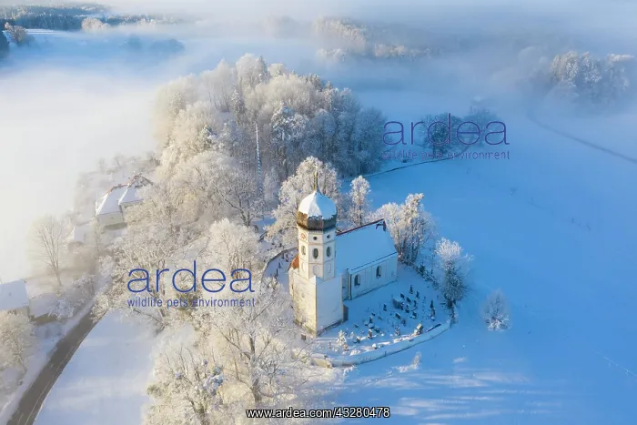 : Snow-covered church St. Johann Baptist. Fog mood : Snow-covered church St. Johann Baptist. Fog mood
