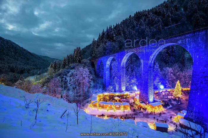 : Snowy Christmas market under a railway viaduct : Snowy Christmas market under a railway viaduct