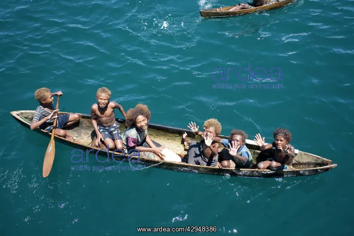 : Solomon Islands children in canoe : Solomon Islands children in canoe